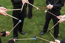 members holding drum sticks